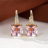 Boucles d'oreilles en or avec des pierres mystérieuses